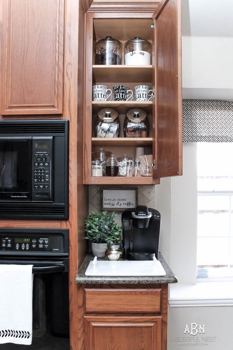 This is such a great idea! Transform a dead cabinet space with these coffee cabinet organization ideas! See more on https://ablissfulnest.com/ #coffee #coffeestation