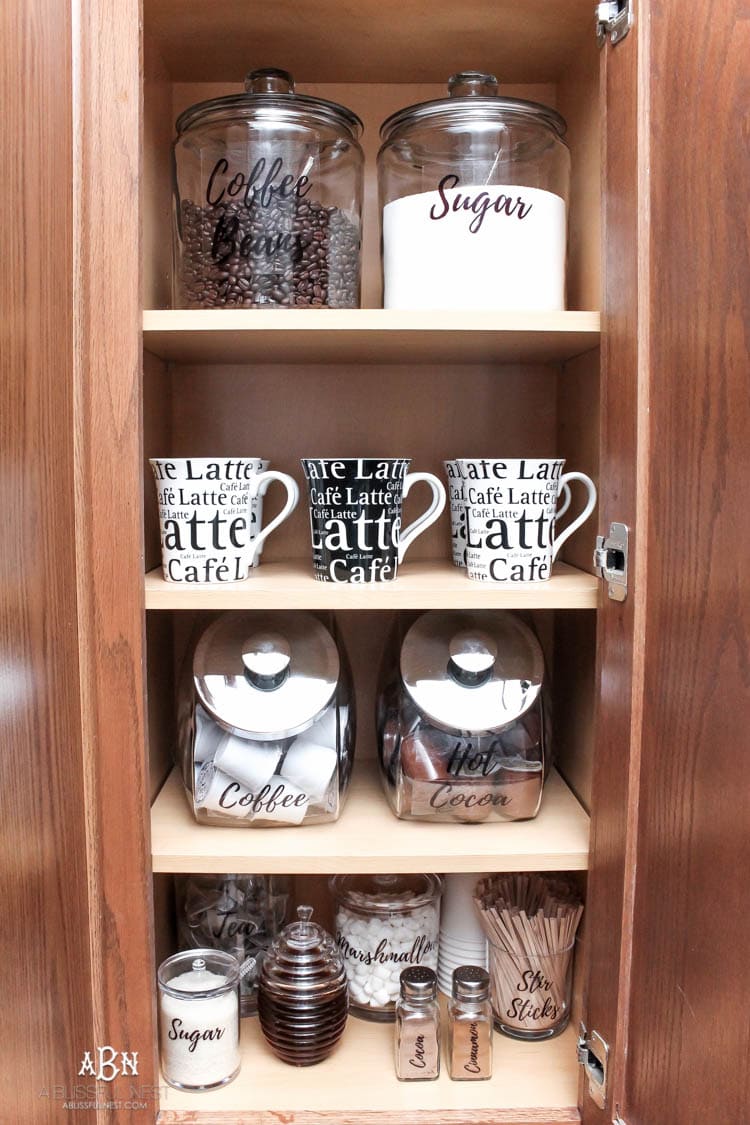 This is such a great idea! Transform a dead cabinet space with these coffee cabinet organization ideas! See more on https://ablissfulnest.com/ #coffee #coffeestation