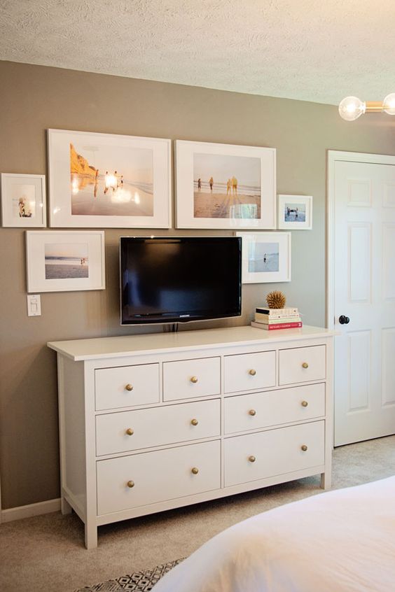 Aim for symmetry and balance in your TV gallery wall by hanging artwork equally on each side of the TV