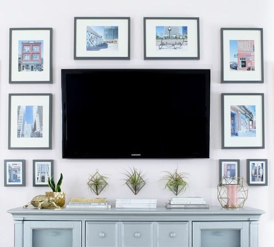 The colorful photos in this TV gallery wall make the TV the focus of the space and all the colors match and look so cohesive together