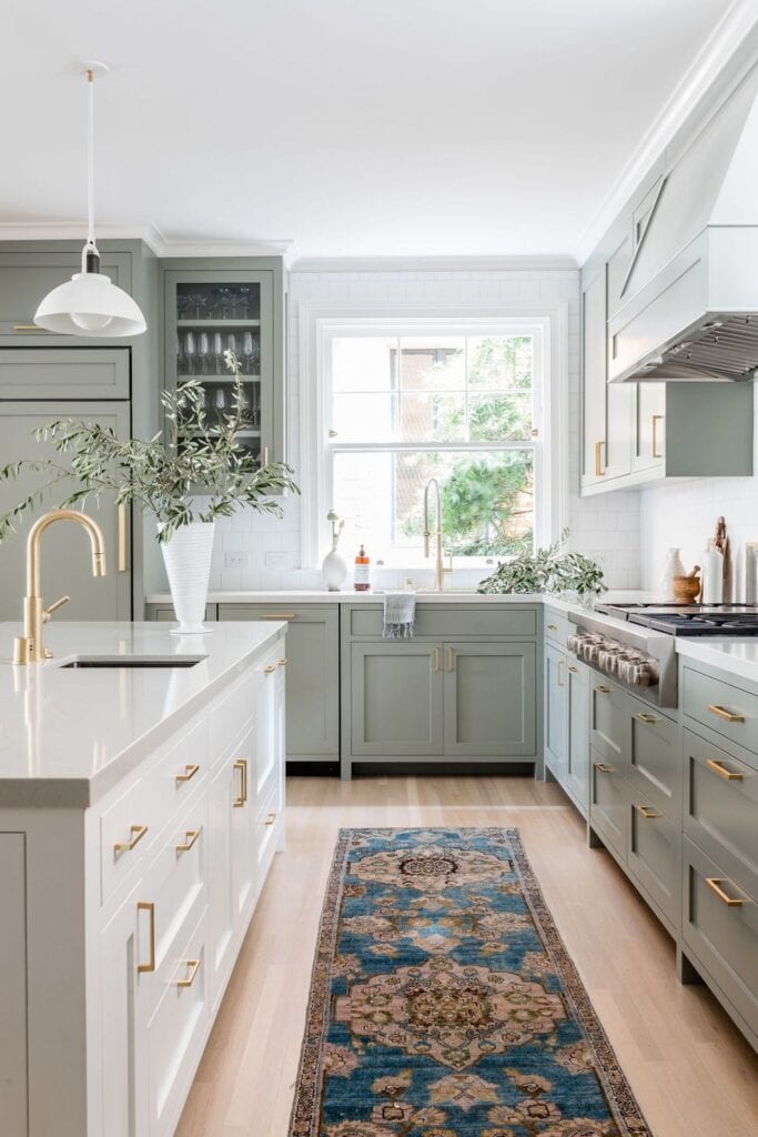 Sage green kitchen cabinets with white kitchen island. #cabinetcolors #kitchenideas #kitchens