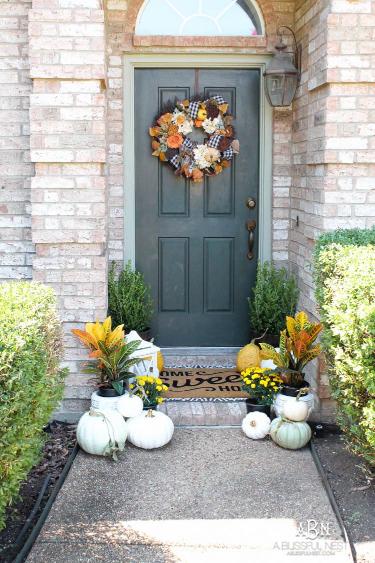 Classic colors with a pop of pattern make this gorgeous fall front porch! #fallfrontporch #falldecorideas