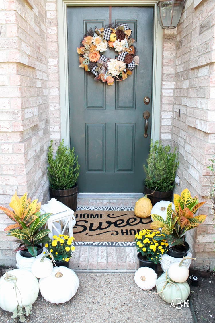 Classic colors with a pop of pattern make this gorgeous fall front porch! #fallfrontporch #falldecorideas