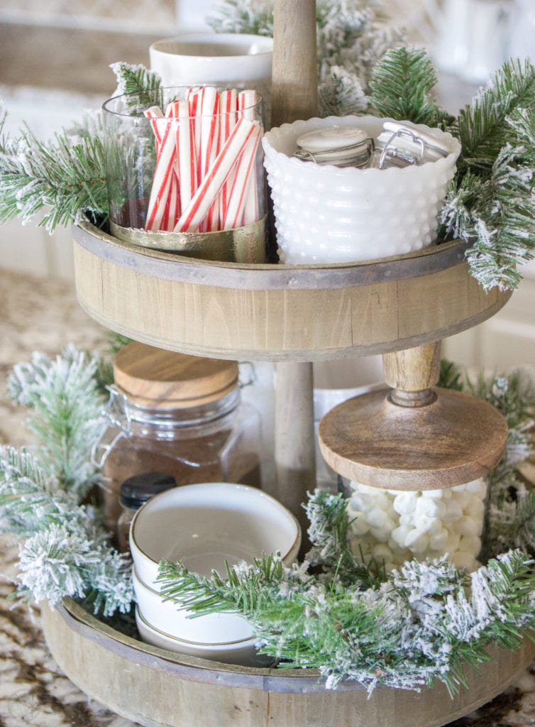 A Fully Stocked Hot Cocoa Station that can stay out on display all season long. See how to use a tiered tray to create a hot cocoa station that is perfect for entertaining. #hotcocoabar #hotcocoastation #tieredtray #winterweddingideas