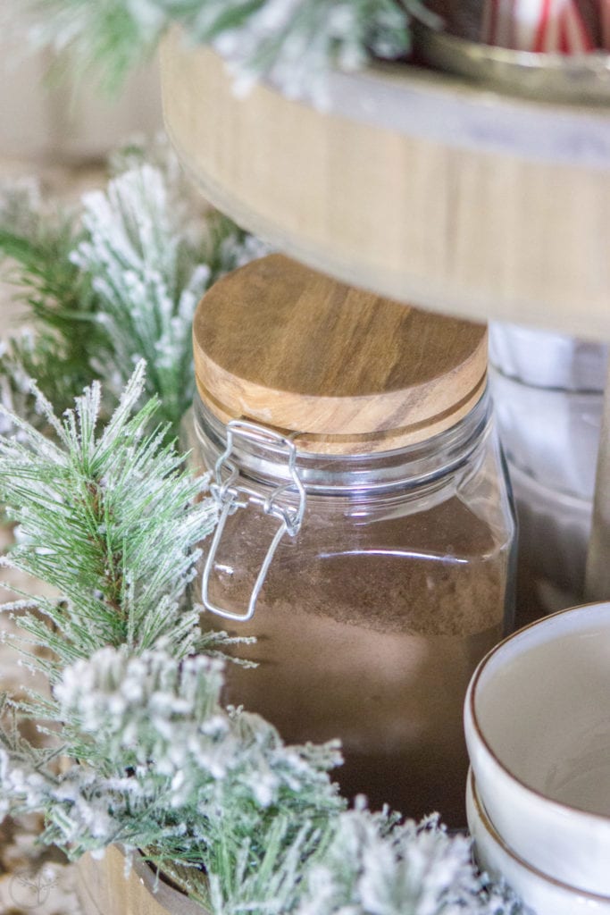 A Fully Stocked Hot Cocoa Station that can stay out on display all season long. See how to use a tiered tray to create a hot cocoa station that is perfect for entertaining. #hotcocoabar #hotcocoastation #tieredtray #winterweddingideas