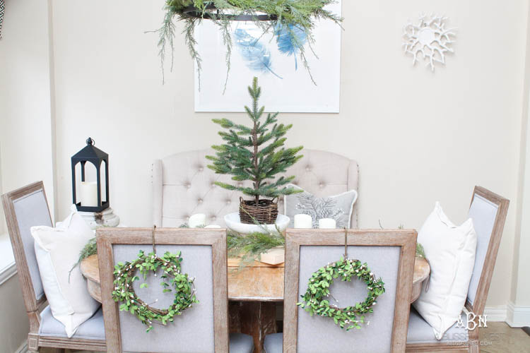 A classic christmas porch and beautiful neutral Christmas dining room idea. See more on https://ablissfulnest.com/ #christmasdecor #christmasideas #christmasfront porch #christmasdecoratingideas