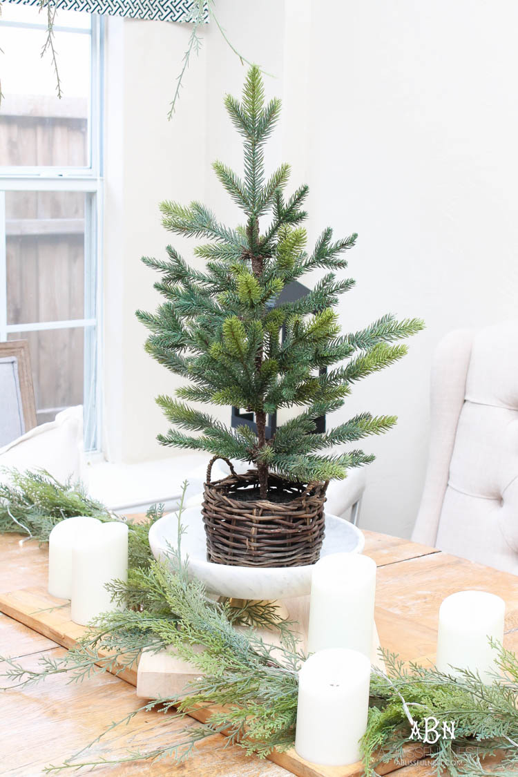 A classic christmas porch and beautiful neutral Christmas dining room idea. See more on https://ablissfulnest.com/ #christmasdecor #christmasideas #christmasfront porch #christmasdecoratingideas