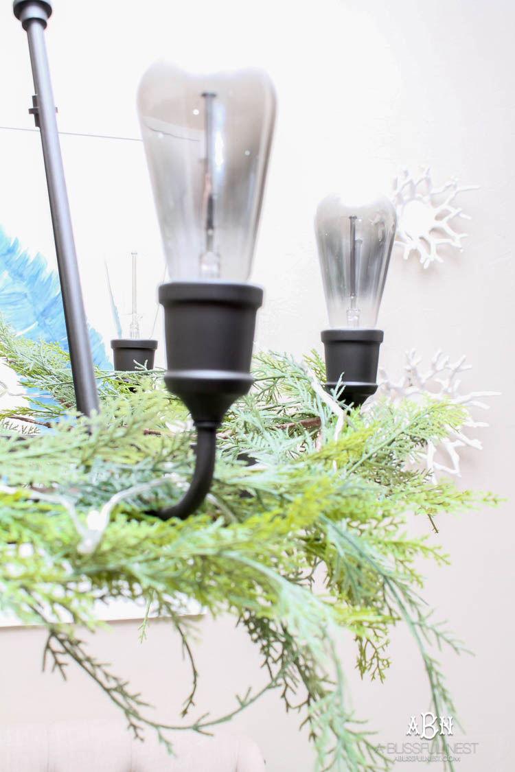 A classic christmas porch and beautiful neutral Christmas dining room idea. See more on https://ablissfulnest.com/ #christmasdecor #christmasideas #christmasfront porch #christmasdecoratingideas