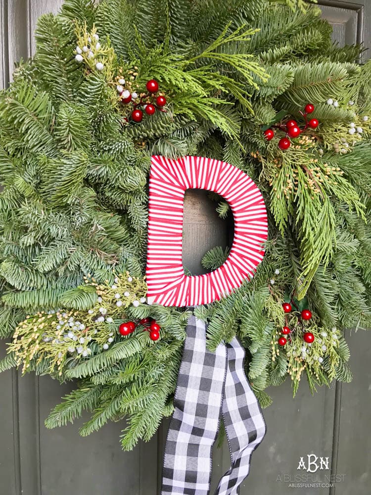 A classic christmas porch and beautiful neutral Christmas dining room idea. See more on https://ablissfulnest.com/ #christmasdecor #christmasideas #christmasfront porch #christmasdecoratingideas