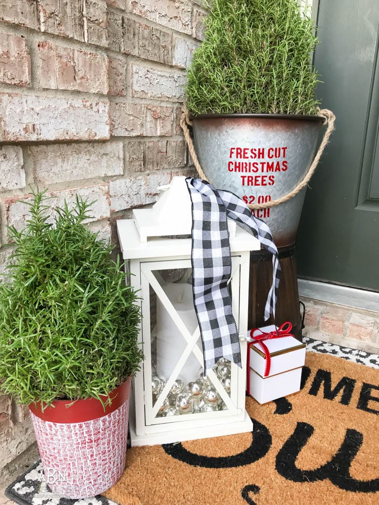 A classic christmas porch and beautiful neutral Christmas dining room idea. See more on https://ablissfulnest.com/ #christmasdecor #christmasideas #christmasfront porch #christmasdecoratingideas