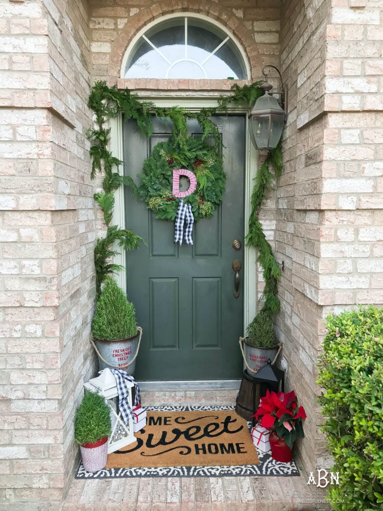 A classic christmas porch and beautiful neutral Christmas dining room idea. See more on https://ablissfulnest.com/ #christmasdecor #christmasideas #christmasfront porch #christmasdecoratingideas