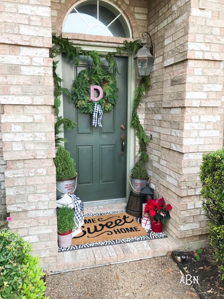 A classic christmas porch and beautiful neutral Christmas dining room idea. See more on https://ablissfulnest.com/ #christmasdecor #christmasideas #christmasfront porch #christmasdecoratingideas