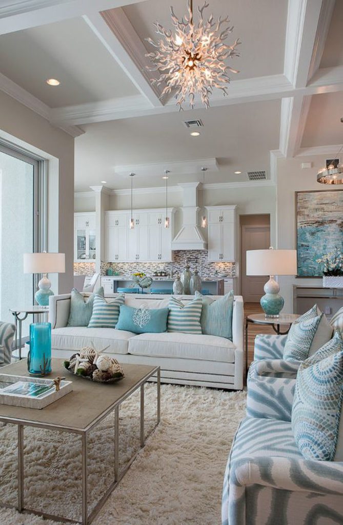 Turquoise pillows on a cream sofa, turquoise zebra stripe chairs, table lamps and candles.