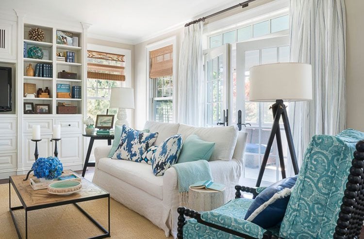 Turquoise chair and pillows paired with navy, cream and tan home decor accents.