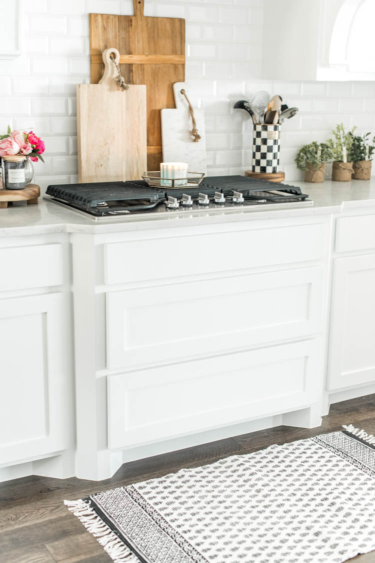 Spring touches are easy to add to a kitchen with accessories. #ad #AthomeStores #springdecorating #springdecoratingideas #kitchen #springkitchen #whitekitchen