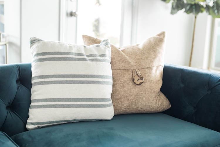 Use accent pillows for some spring flare! #ad #AthomeStores #springdecorating #springdecoratingideas #coastallivingroom