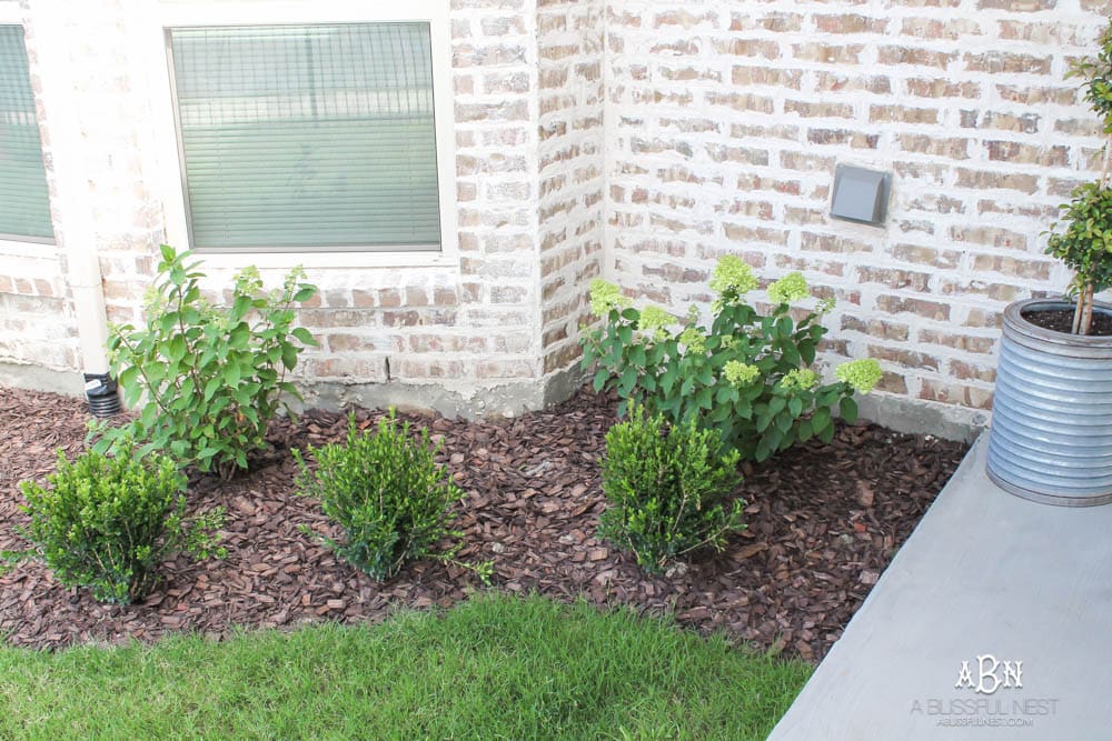 A small backyard makeover before and after with ideas on small backyard landscaping ideas. #ad #husqvarna #backyardideas #brickhouse #landscaping