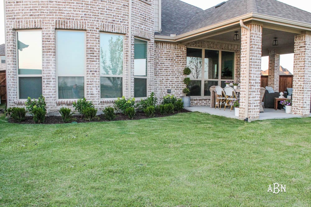 A small backyard makeover before and after with ideas on small backyard landscaping ideas. #ad #husqvarna #backyardideas #brickhouse #landscaping