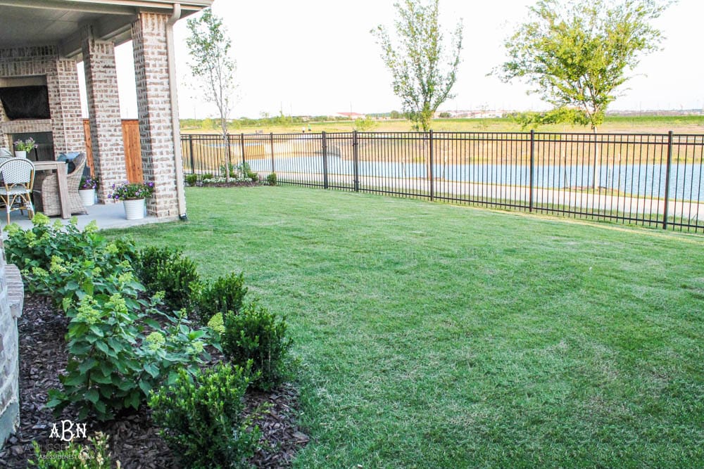 A small backyard makeover before and after with ideas on small backyard landscaping ideas. #ad #husqvarna #backyardideas #brickhouse #landscaping
