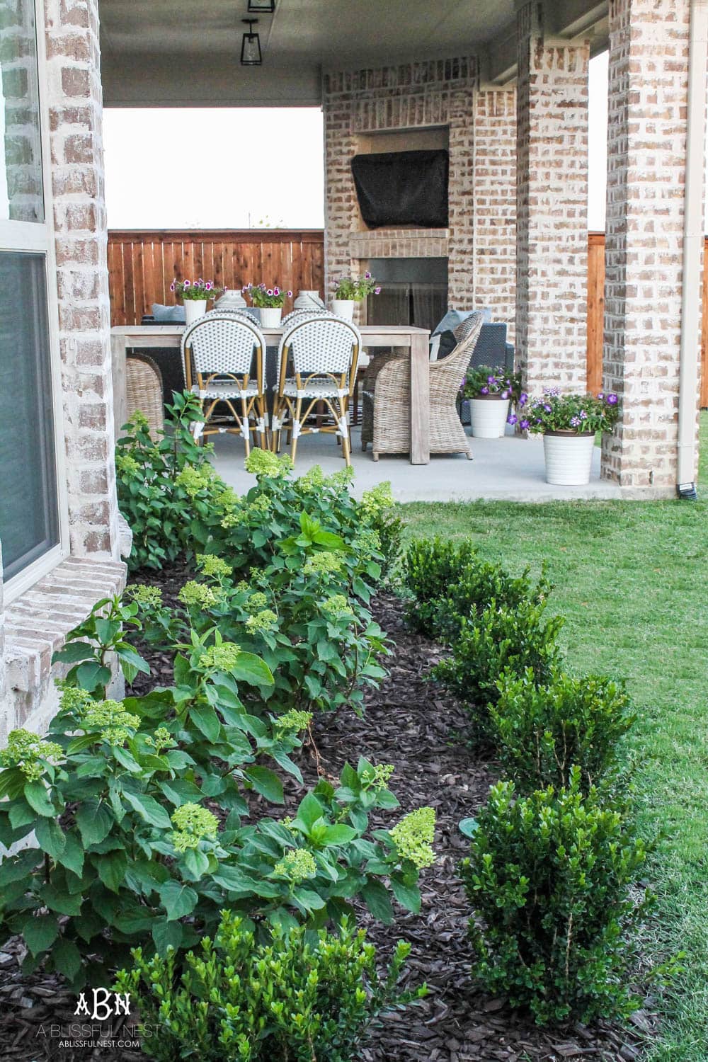 A small backyard makeover before and after with ideas on small backyard landscaping ideas. #ad #husqvarna #backyardideas #brickhouse #landscaping