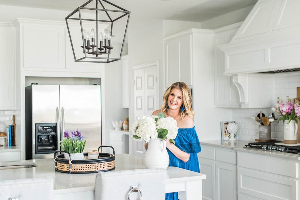 Beautiful summer accents in this all white kitchen. More white kitchen ideas on https://ablissfulnest.com #ABlissfulNest #whitekitchen #kitcheninspiration #kitchenideas