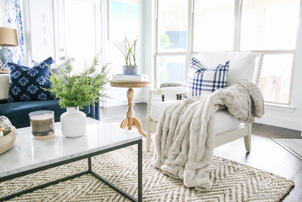 Beautiful blue and silver Christmas living room decor in a bright white space with juniper garland and silver and blush ornaments. Check out all the white, silver and gold Christmas decor in this holiday home tour on ABlissfulNest.com. #ABlissfulNest #Christmasdecor #Christmasdecorating #CoastalChristmasdecor #christmastree #christmasmantle