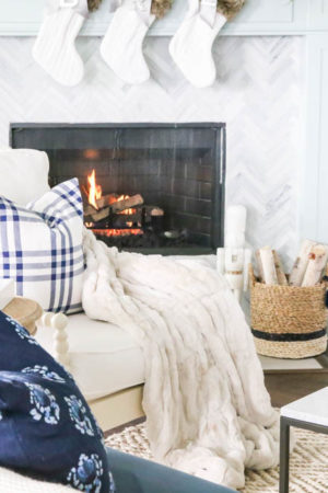 Beautiful blue and silver Christmas living room decor in a bright white space with juniper garland and silver and blush ornaments. Check out all the white, silver and gold Christmas decor in this holiday home tour on ABlissfulNest.com. #ABlissfulNest #Christmasdecor #Christmasdecorating #CoastalChristmasdecor