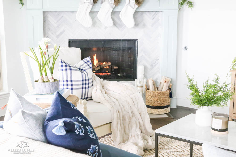 Beautiful blue and silver Christmas living room decor in a bright white space with juniper garland and silver and blush ornaments. Check out all the white, silver and gold Christmas decor in this holiday home tour on ABlissfulNest.com. #ABlissfulNest #Christmasdecor #Christmasdecorating #CoastalChristmasdecor