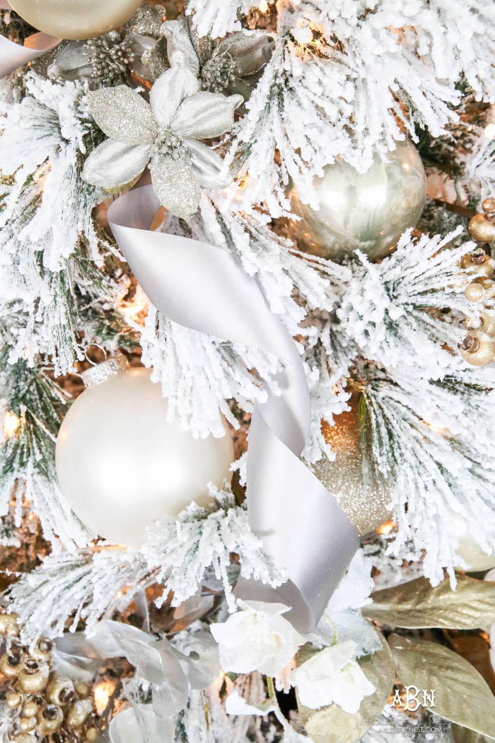 Silver and gold Christmas tree in an open concept floor plan with lots of blue home decor accents. Check out all the white, silver and gold Christmas decor in this holiday home tour on ABlissfulNest.com. #ABlissfulNest #Christmasdecor #Christmasdecorating #CoastalChristmasdecor #christmastree