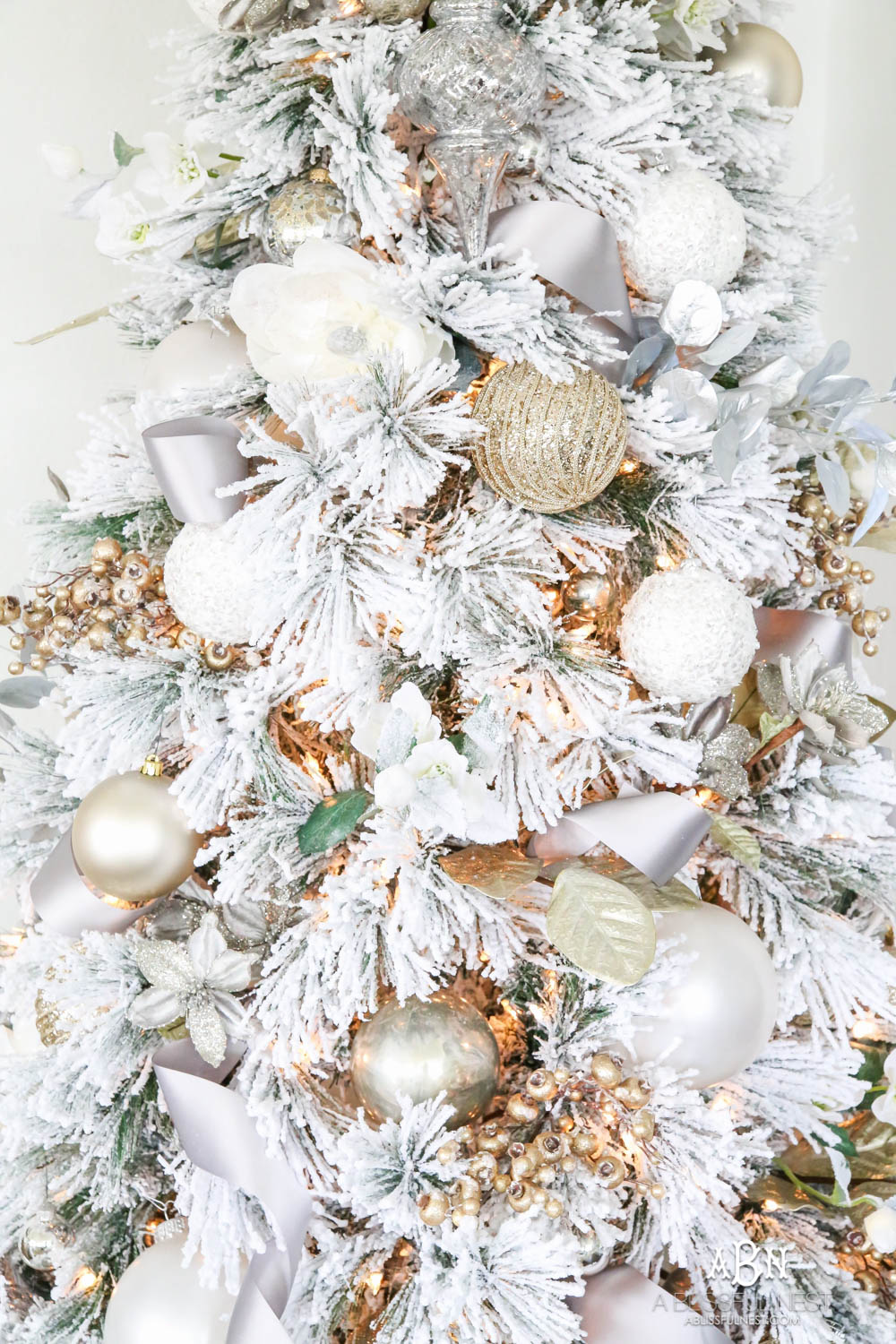 Silver and gold Christmas tree in an open concept floor plan with lots of blue home decor accents. Check out all the white, silver and gold Christmas decor in this holiday home tour on ABlissfulNest.com. #ABlissfulNest #Christmasdecor #Christmasdecorating #CoastalChristmasdecor