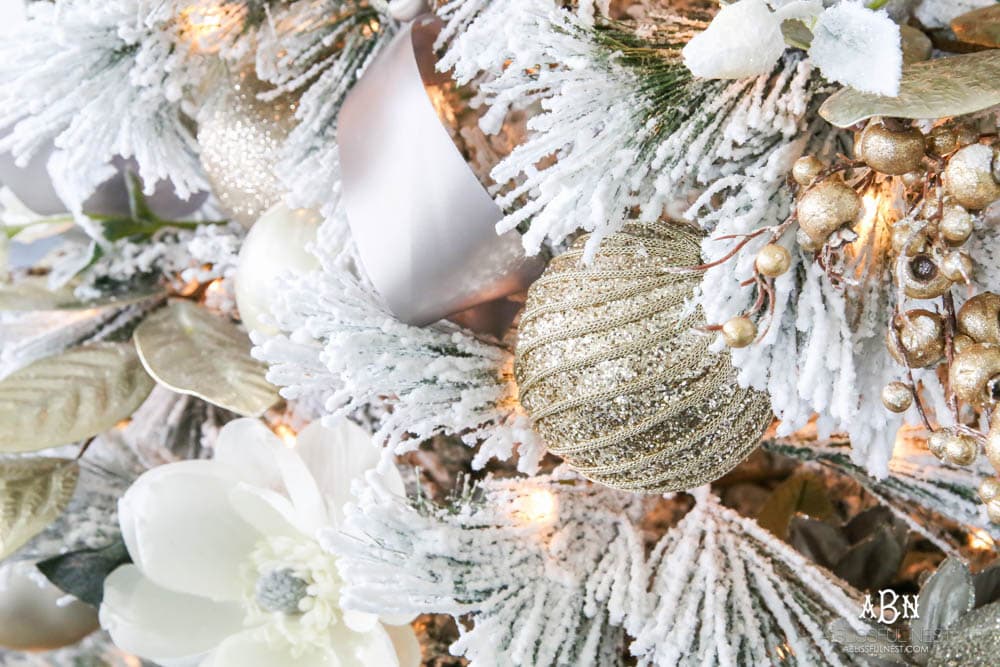 Silver and gold Christmas tree in an open concept floor plan with lots of blue home decor accents. Check out all the white, silver and gold Christmas decor in this holiday home tour on ABlissfulNest.com. #ABlissfulNest #Christmasdecor #Christmasdecorating #CoastalChristmasdecor