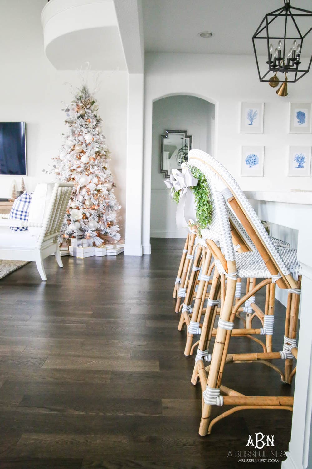 Beautiful blue and silver Christmas living room decor in a bright white space with juniper garland and silver and blush ornaments. Check out all the white, silver and gold Christmas decor in this holiday home tour on ABlissfulNest.com. #ABlissfulNest #Christmasdecor #Christmasdecorating #CoastalChristmasdecor #christmastree #christmasmantle