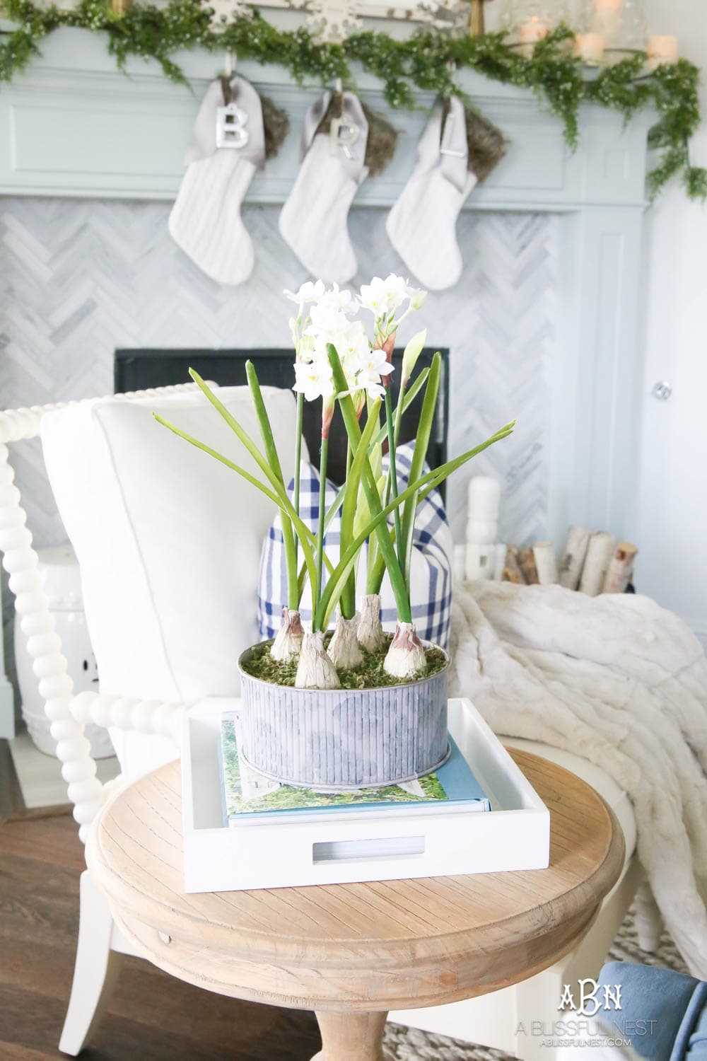 Beautiful blue and silver Christmas living room decor in a bright white space with juniper garland and silver and blush ornaments. Check out all the white, silver and gold Christmas decor in this holiday home tour on ABlissfulNest.com. #ABlissfulNest #Christmasdecor #Christmasdecorating #CoastalChristmasdecor #christmastree #christmasmantle