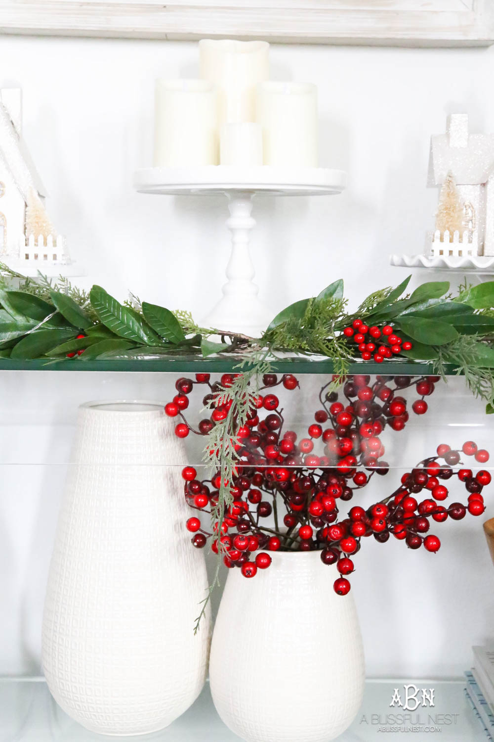 Pop holiday berries into your existing décor. Beautiful pop of color in this classic Christmas décor in this entryway. #christmasentryway #christmasentry #christmasentrydecor #christmasentrywayideas #christmashometour