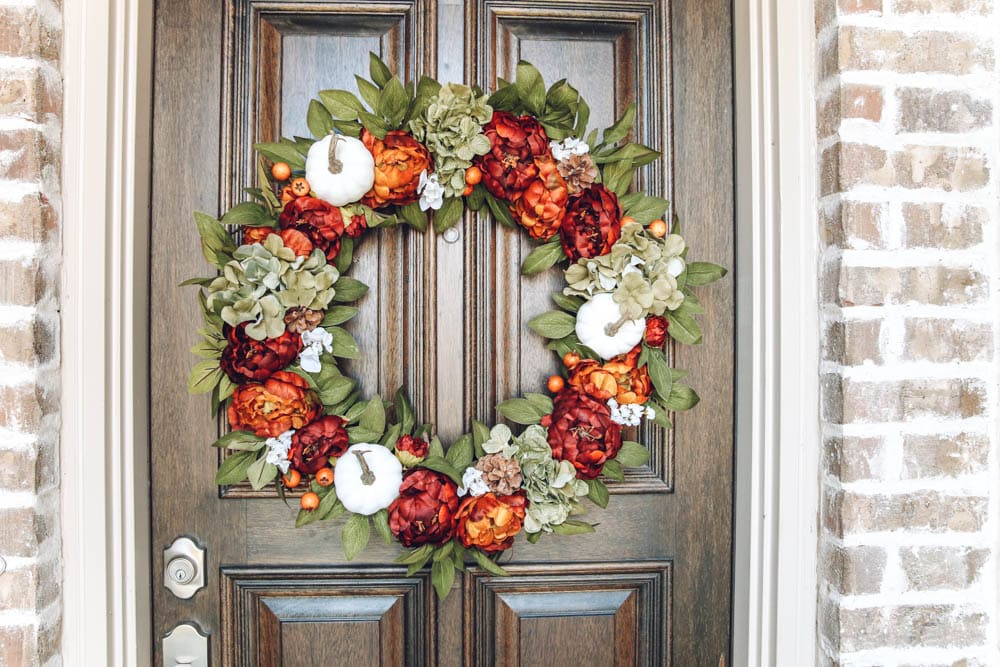 Beautiful burnt orange, muted green, mini pumpkins, hydrangea and small berries. Gorgeous fall wreath details. #ABlissfulNest #fallporch #fallinspiration 