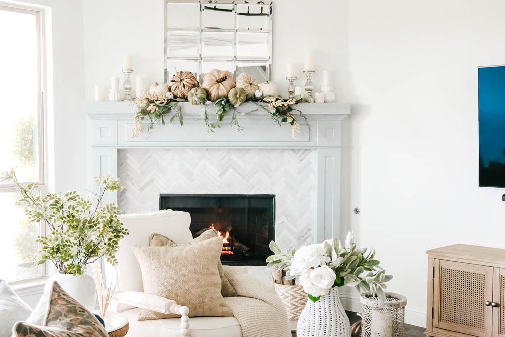 Coastal fireplace mantle decorated for fall. Natural pumpkins, neutral fall decor ideas for the living room. #ABlissfulNest #falldecor #falldecoratingideas #livingroomideas #fireplacemantle
