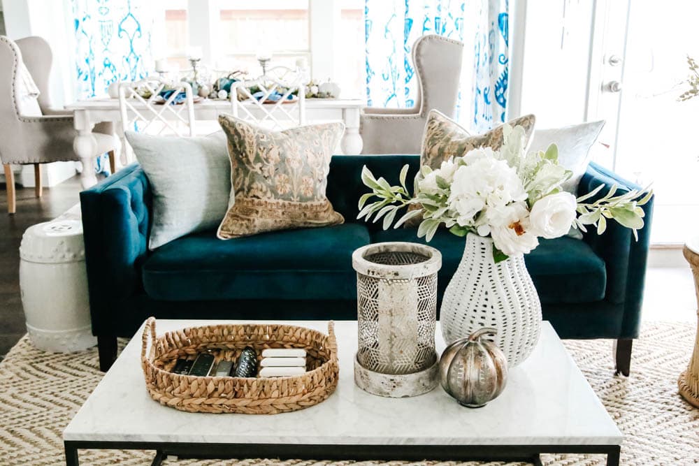 Neutral fall decor with navy sofa and pops of blue in a coastal inspired living room. #ABlissfulNest #fallhometour #falldecor #fallinspiration #livingroomideas