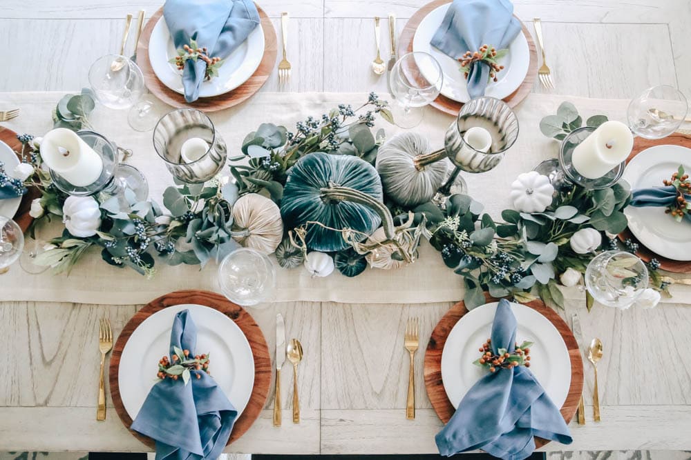 Pops of blue in napkins, pumpkins and berries create a beautiful layered look in this fall table. #ABlissfulNest #fall #thanksgiving #falldecor