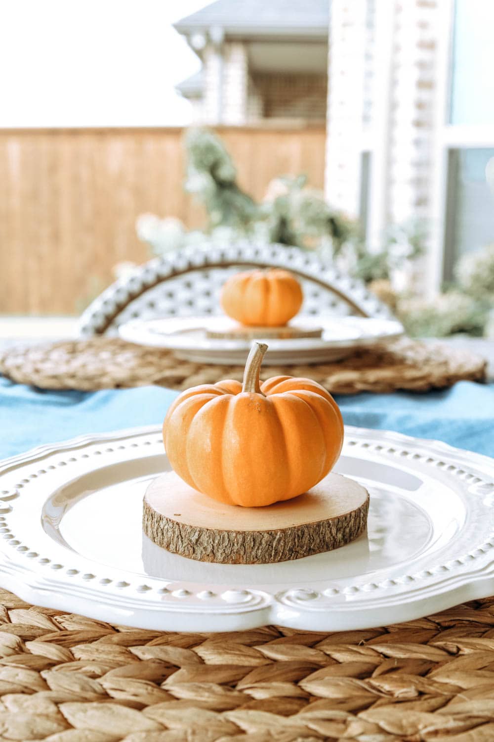 Mini pumpkins, white plates, wood accents. #ABlissfulNest #falldecor #falltable #thanksgiving