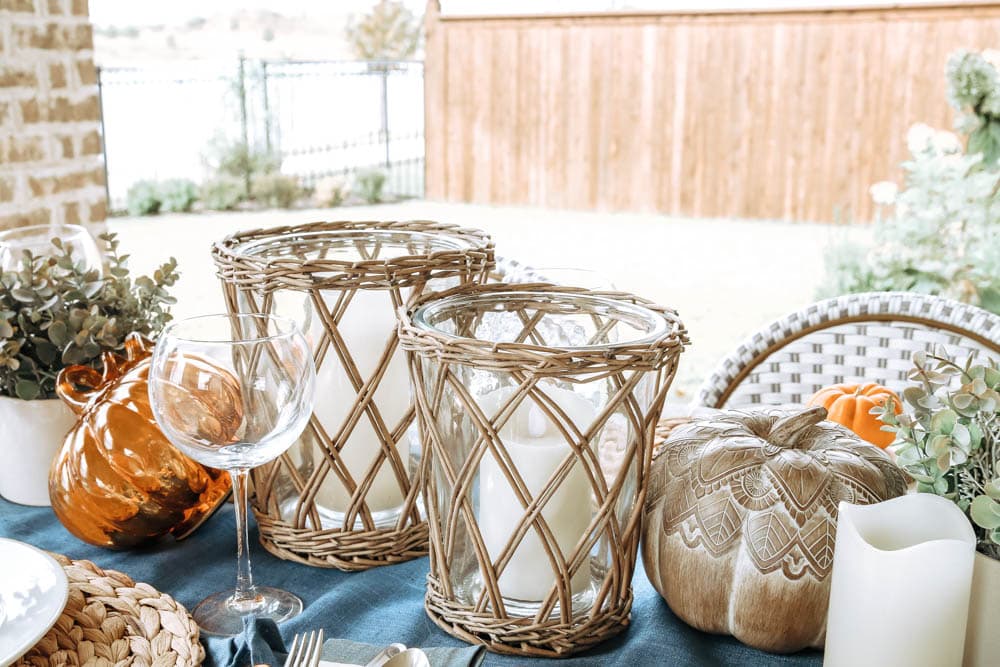 Beautiful basket weave hurricane vases, candles and pumpkins. Create gorgeous ambience for a fall table. #ABlissfulNest #falltable #fallinspiration #falldecor