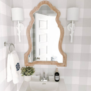 Wood mirror, white faux bois sconces and grey and white buffalo check wallpaper in this coastal bathroom design. #ABlissfulNets #bathroom #farmhouse #bathroomdesign