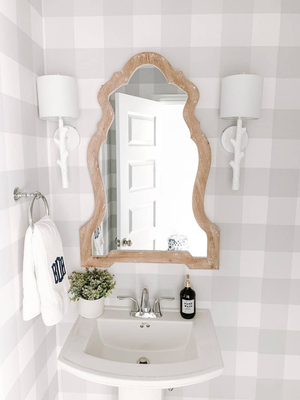 Wood mirror, white faux bois sconces and grey and white buffalo check wallpaper in this coastal bathroom design. #ABlissfulNets #bathroom #farmhouse #bathroomdesign