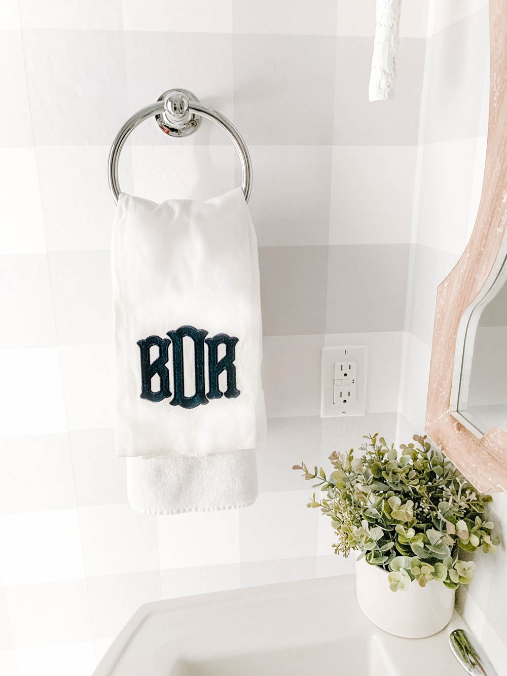 Navy blue and white monogrammed towel personalizes a beautiful powder bathroom. #ABlissfulNest #bathroommakeover #bathroom #bathroomdecor #farmhouse