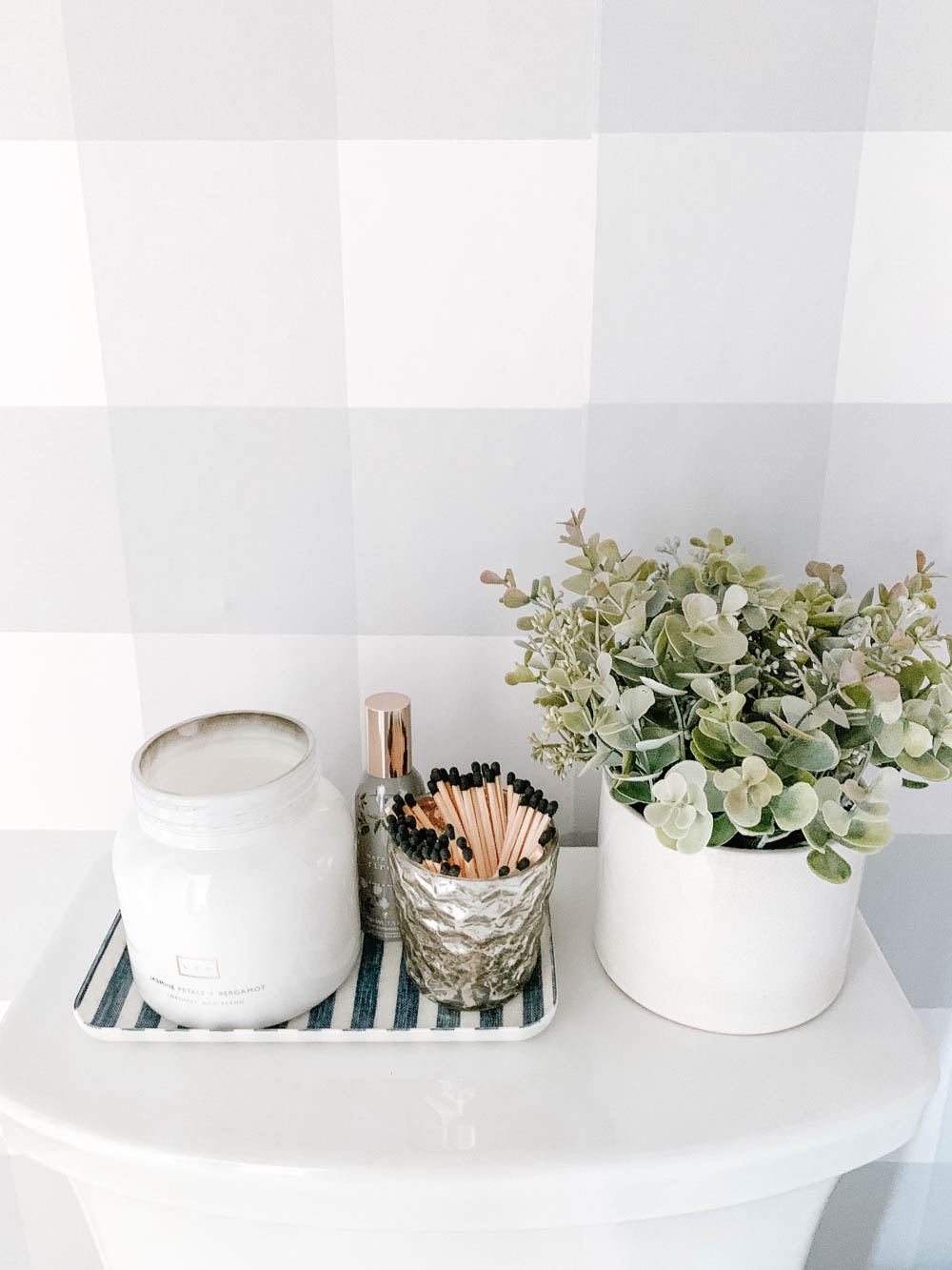 Pretty little bathroom details like a scented candle, matches in a mercury glass jar and a potted plant. #ABlissfulNest #bathroom #bathroomdesign