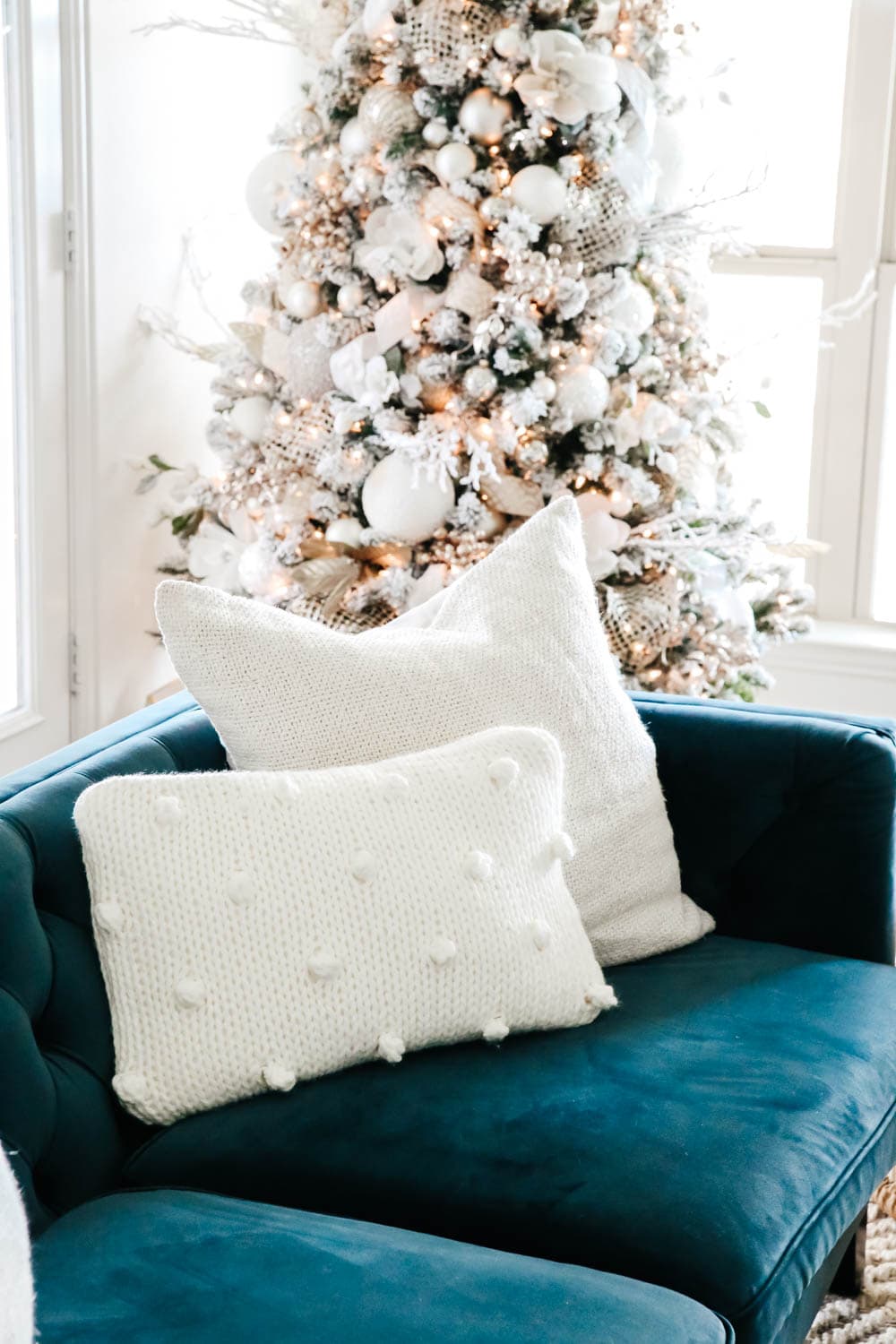 Beautiful pom pom pillow and neutral Christmas tree paired with this blue velvet sofa for the holidays. #ABlissfulNest #christmasdecorating #christmasdecorideas