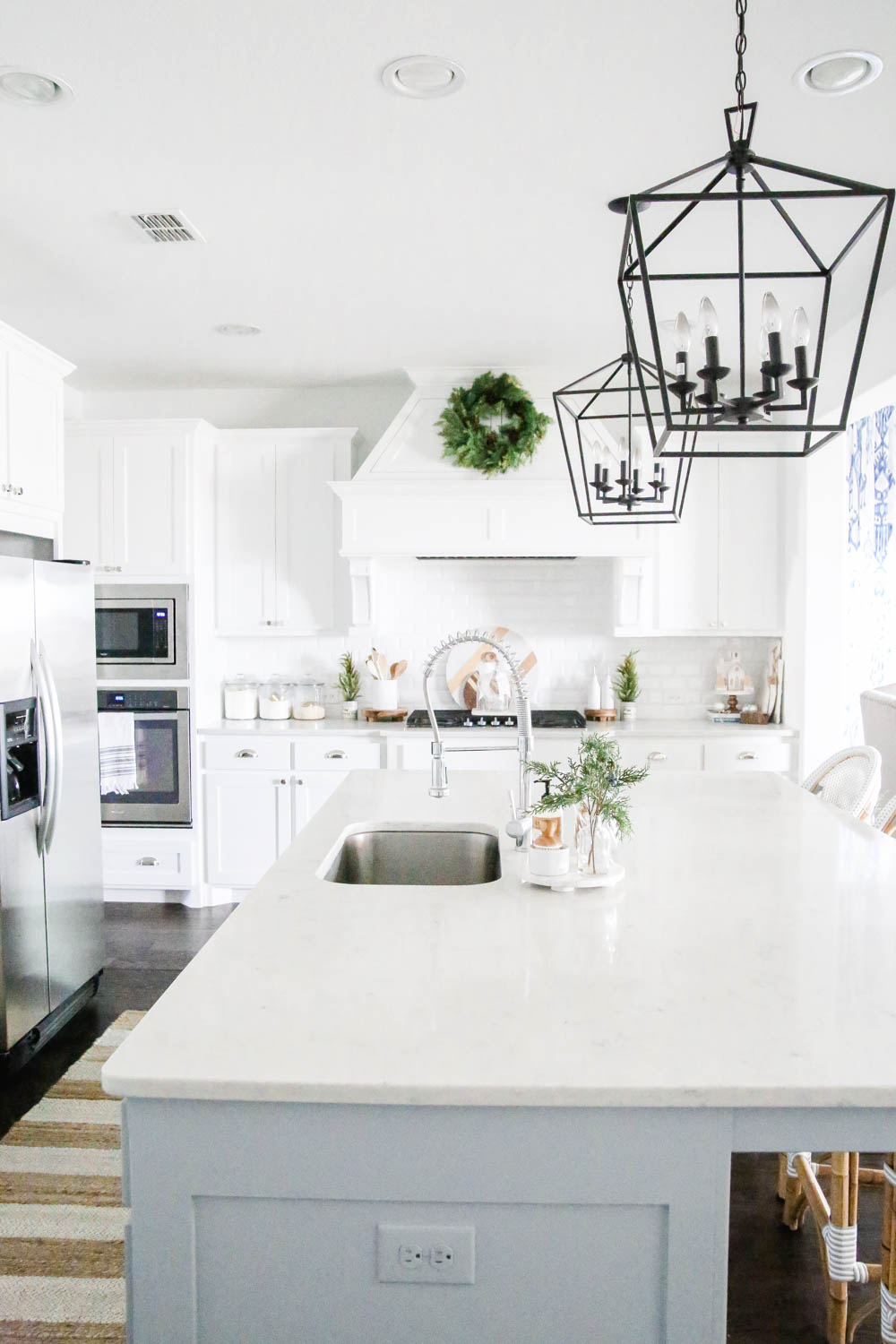 White kitchen with winter green Christmas decor. #ABlissfulNest #Christmasdecor #holidaydecorating