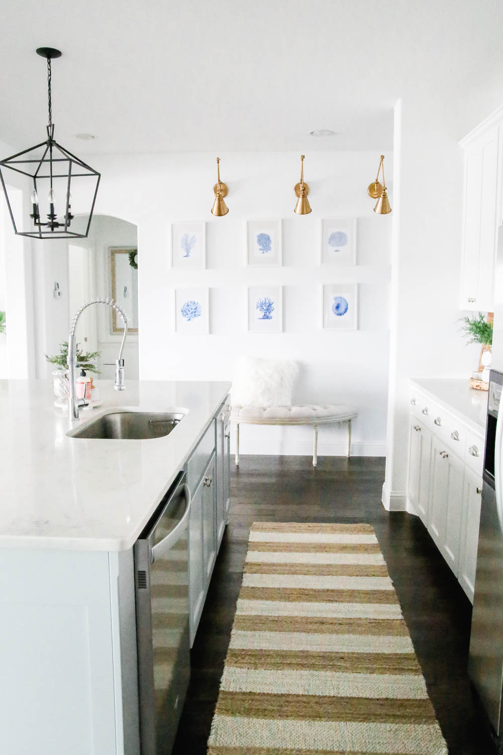 blue and white coastal art prints, white kitchen with sisal just runner. #ABlissfulNest #whitekitchen #coastaldecor