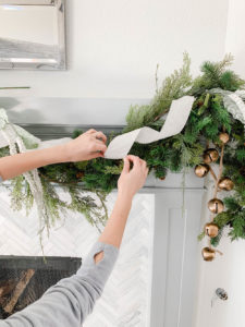 How To Hang Holiday Garland Without Damaging Your Mantel