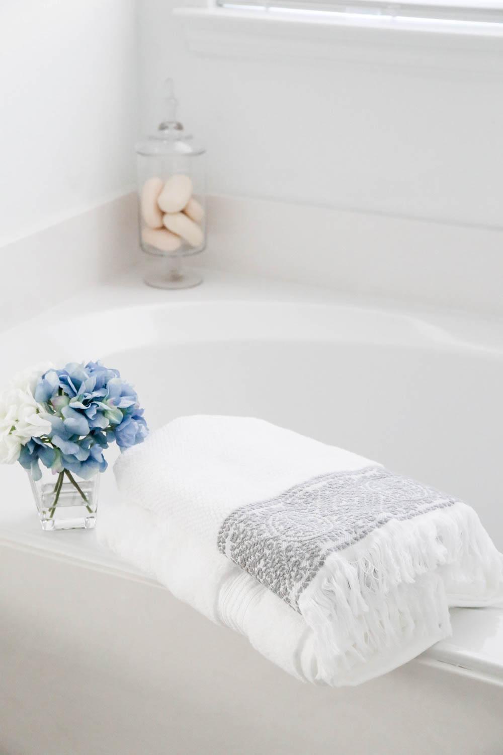 Add fresh towels and layer with different patterns in a bathroom refresh. #AtHomeStores #AtHomeFinds #ad