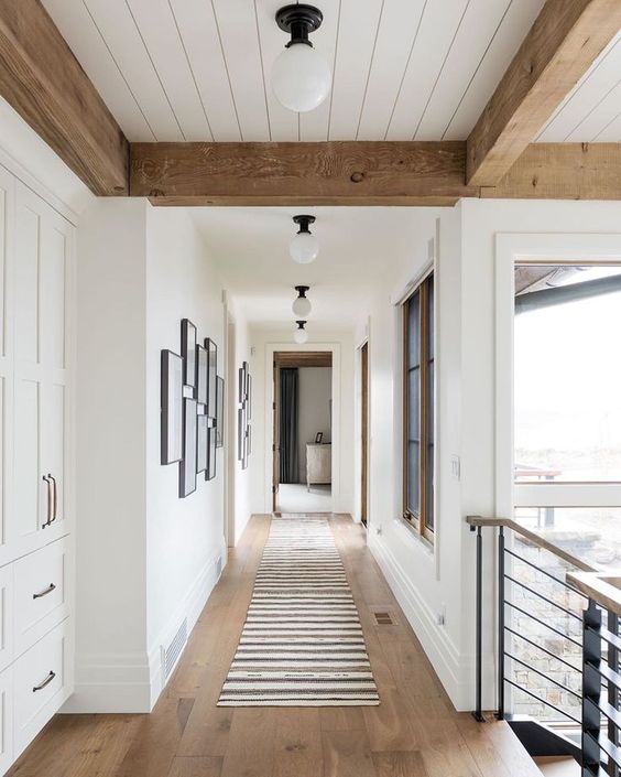 Beautiful flush mount fixtures in this hallway by Studio Mcgee.